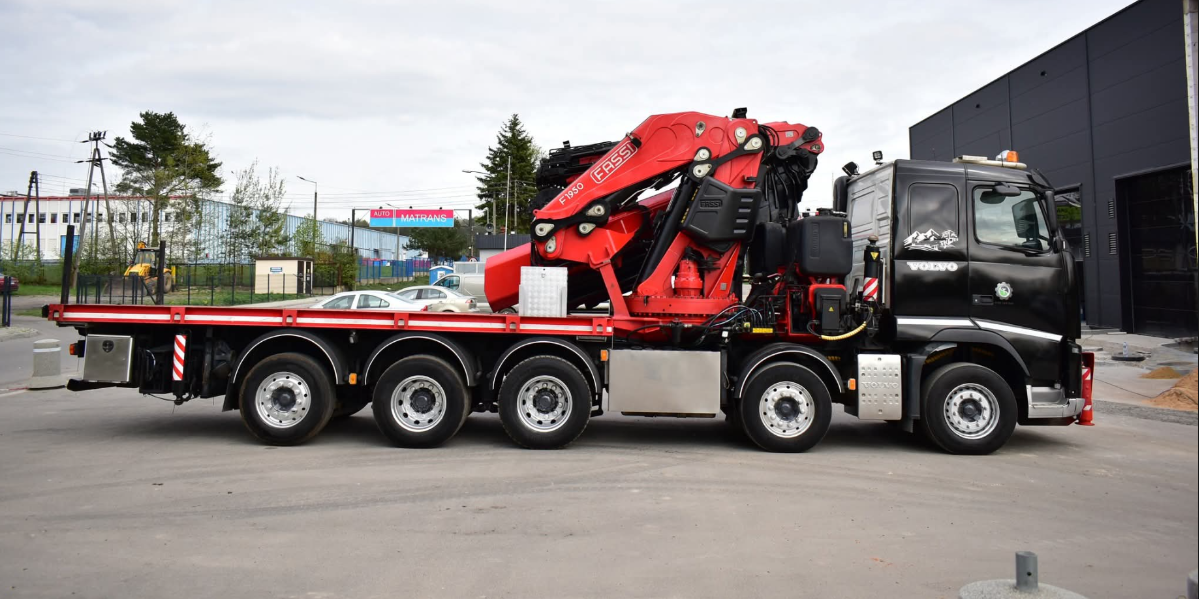 Low loader transporting heavy equipment